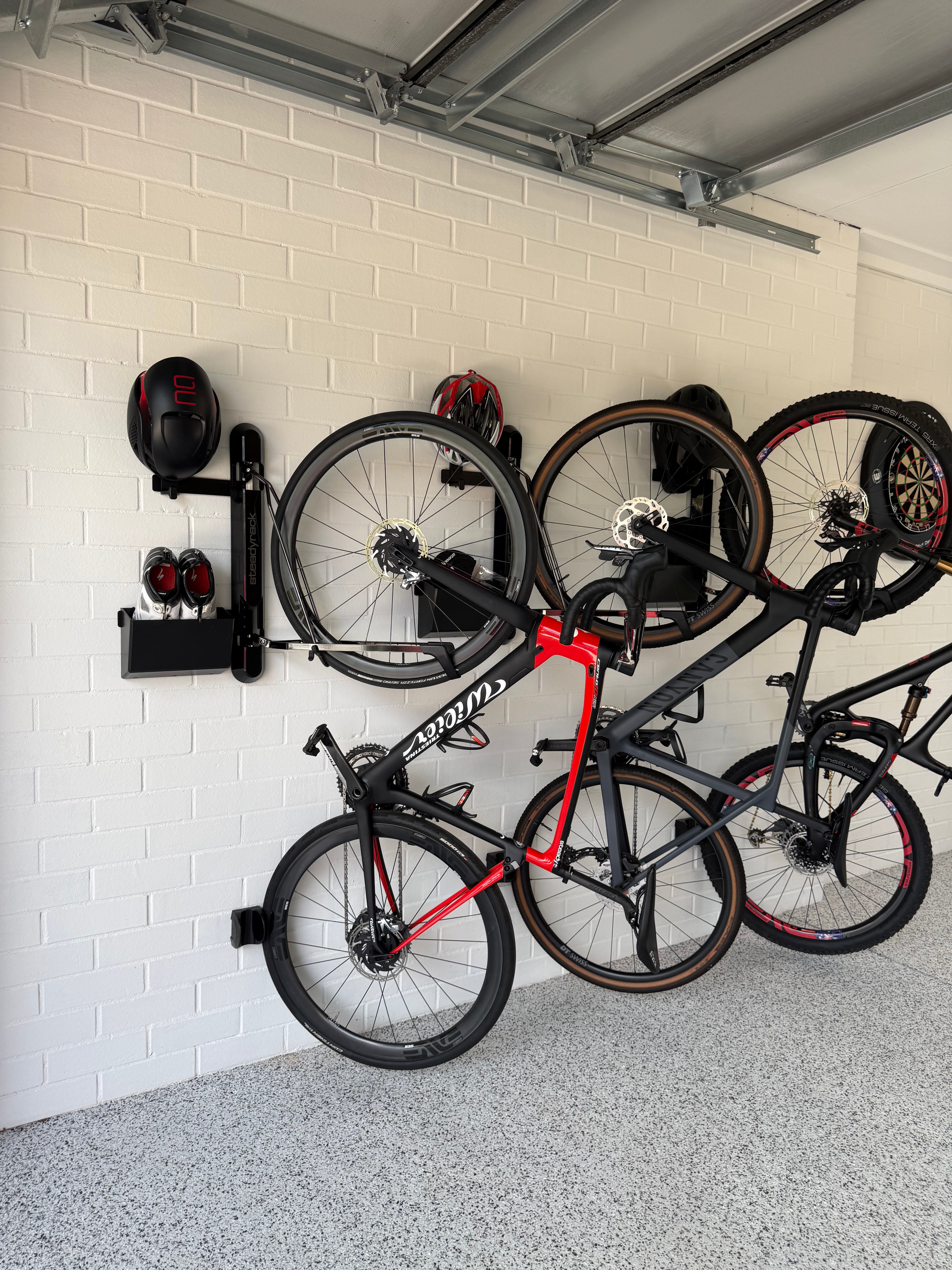 Bicycles mounted on a wall rack in a garage setting